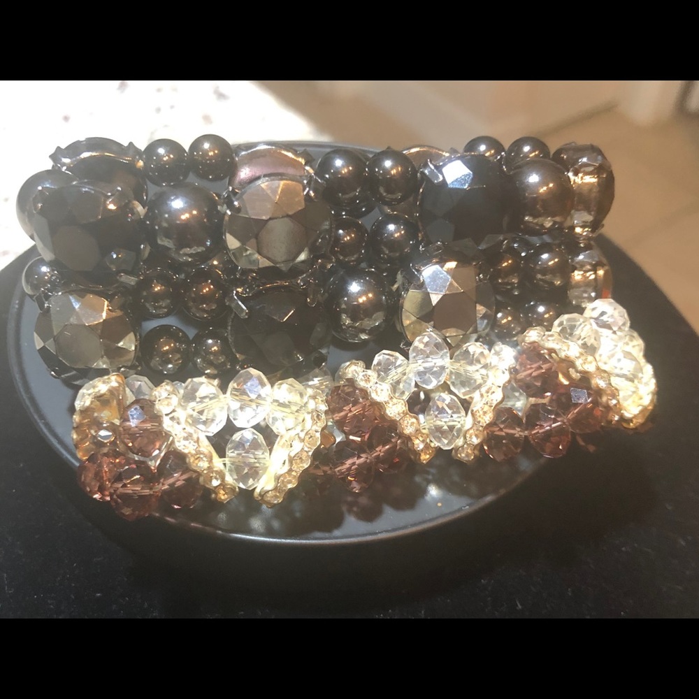 A pair of black crystal/purple stretch bracelets